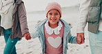 Parents, beach and face of child holding hands outdoors on holiday, vacation and weekend. Winter, travel and portrait of young girl walking with happy family for bonding, adventure and relax by sea