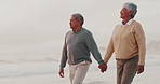 Senior couple, holding hands and walk at beach with love, care and connection for relationship on vacation. Elderly man, old woman and people with romance, memory and holiday by sea in retirement