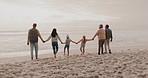 Family, holding hands and grandparents with children on beach for holiday, vacation and adventure in winter. Walking, travel and mother, father and kids for bonding, relationship and relax by sea