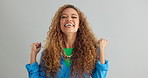 Happy woman, fist pump and celebration with deal, promotion or winning on a gray studio background. Portrait of excited female person or winner with applause in surprise for bonus on mockup space