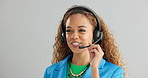 Happy woman, consultant and talking with headphones for customer service or call center on a gray studio background. Young female person or agent consulting for online advice or help on mockup space