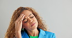 Frustrated woman, headache and stress with anxiety, depression or mental health on a gray studio background. Face of tired female person in fatigue, pressure or tension with overwhelmed emotion