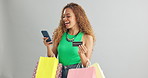 Happy woman, phone and credit card with shopping bags for payment on a gray studio background. Female person with smile or debit on mobile smartphone for online purchase, banking or app on mockup