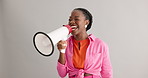 Megaphone, excited and black woman on gray background for news, announcement and information. Bullhorn, communication and person with speaker for discount, sale and bargain broadcast in studio