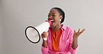 Megaphone, shout and excited black woman on gray background for news, announcement and information. Bullhorn, communication and person with speaker for discount, sale and bargain broadcast in studio