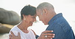 Mature, couple and hug on beach for love or affection for romance on retired vacation with support or trust. Senior, man and woman forehead together for embrace on holiday for commitment and bonding.