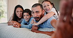 Funny face, family and selfie in home bedroom, tongue out and kids bonding together in the morning. Portrait, smile and parents take picture with children for happy memory, relax and social media