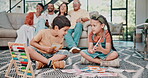 Siblings, learn and flash cards on floor, family and sofa in home living room. Education, childhood and development with parents or grandparents on couch, movies and young children on ground  