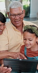 Grandparents, laughing or girl with tablet in a family home for movie streaming, video or education learning. Relax, child or happy senior grandfather on sofa with grandma, kids or film on technology