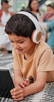 Tablet, study and boy child on living room floor of home for elearning, tutorial or homework. Kids, online education and website with happy young son in apartment for research, streaming or browsing