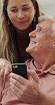 Home, old couple and smartphone with typing, connection and conversation with social media and digital app. Apartment, senior man and mature woman with cellphone and mobile user with internet or tech