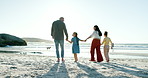 Happy family, holding hands and walking together on beach, sunset and love with bonding on summer holiday. Father, mother and kids on sea sand with talking, blue sky and relax in nature on vacation