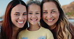 Beach, face and mother with granny, girl and happiness with hug or bonding together with vacation. Portrait, family, mama or grandma with girl or embrace with kid or childhood with seaside or holiday