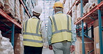 Warehouse, distribution and men walking in a manufacturing, export and storage company. Talk, back and business people with inspection of freight and supply chain with construction gear in factory