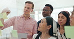 Business, planning and writing on glass in collaboration of brainstorming, solution or ideas on board in office. Staff, teamwork and man with strategy on wall and discussion of notes in workplace
