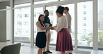 Business people, walking and meeting with handshake for greeting, collaboration or partnership at office. Group of employees shaking hands for introduction, hiring or recruiting together at workplace