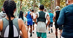 Exercise, marathon and crowd of people running on road outdoor for cardio, wellness or healthy body. Athlete, group and back in race competition, workout and training for sports at park for fitness