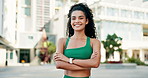 Woman, runner and arms crossed with smile in city for workout, training or health on metro street. Girl, person and outdoor with confidence for exercise, fitness or wellness on urban road in Colombia