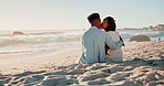 Couple, kissing and love on sand at beach for romance, affection and bonding on honeymoon vacation in Maldives. Black man, woman or happy by ocean for anniversary date, relax or sunrise for adventure