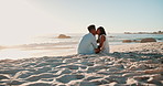 Couple, kiss and love on sand at beach for romance, affection and bonding on honeymoon vacation in Maldives. Black man, woman and happy by ocean for anniversary date, relax and sunset for adventure