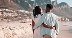 Couple, hug and walking on beach in summer with romance, bonding and holiday or valentines day. Back of a young woman and man talking, happy and enjoying vacation by ocean in Cape Town, South Africa