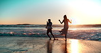 Couple, beach and waves in ocean with playing for vacation, holiday and sunset date in Greece. Man, woman and running in sea water for fun, romance and adventure together in summer with freedom