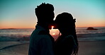 Couple, kissing and love on sand at beach for romance, affection and bonding on honeymoon vacation in Maldives. Black man, woman and happy by ocean for anniversary date, relax and sunset silhouette