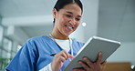 Happy, asian woman and nurse with tablet for research, healthcare or social media at hospital. Female person, medical worker or employee with smile on technology for communication or online search