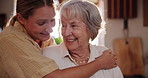 Family, love or hugging with senior mother and daughter in kitchen of home for bonding or visit. Smile, happy or embracing with parent and woman in retirement apartment together on mothers day