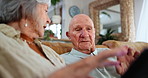 Photo album, retirement and senior couple on sofa in living room of home together for memory nostalgia. Relax, relationship or remembering the past with elderly man and woman talking in apartment