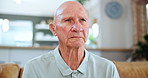 Mature, senior man and mourning while sad, indoor and depressed in house, lounge and living room. Elderly man, closeup and widower with sorrow, despair and lonely on a couch, sofa and retirement home