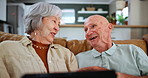 Photo album, smile and senior couple on sofa in living room of home together for memory nostalgia. Relax, retirement or remembering the past with happy elderly man and woman talking in apartment
