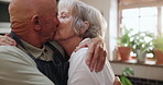 Senior, couple and kiss in kitchen with love, support and care in marriage and retirement. Elderly, man and woman embrace with kindness or gratitude for cooking dinner in home together with happy hug