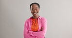 Black woman, arms crossed and portrait with smile in studio for fashion, confidence and pride on grey background. African person, happy and face of person with trendy, style and positive mindset