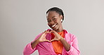 Happy, black woman and heart hands with love for care, support or romance on a gray studio background. Portrait of African female person with smile, like emoji or shape for romantic gesture on mockup