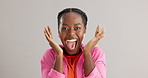 Excited, black woman and surprise with good news for winning, celebration or prize on a gray studio background. Portrait of African female person with smile for lucky draw or lottery on mockup space