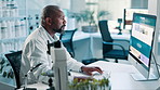 Science, laboratory and black man on computer in clinic for research, website and internet search. Pharmaceutical, healthcare and doctor on pc for medical innovation, data analysis and online report