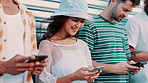 Group, friends and texting with phone in city by garage for contact, blog or connection with diversity. Men, women or gen z people on smartphone, typing or reading for chat, streaming or social media