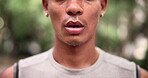 Jogger, park and face with closeup, breathe and exercise for health and wellness. African person, runner and sports with training, workout and fitness for marathon with nature and forest and mindset