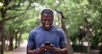 Phone, fitness and happy black man in a park walking with headphones, music or chat in nature. Smartphone, search and male runner in a forest with app for workout tracking, progress or exercise goal