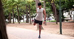 Sports, park or runner stretching legs for fitness training, wellness or exercise outdoors in nature. Man, muscle flexibility or healthy biracial male athlete in warm up to start running workout