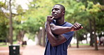 Nature, sports and black man stretching arms for exercise in outdoor park, field or garden. Fitness, health and African male athlete with muscle warm up workout for training with personal trainer.