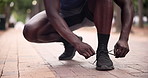 Runner, ground or hands of athlete with shoelace for fitness training, exercise or running workout on road. Begin, wellness or leg of sports man in city with shoes or footwear ready to start practice