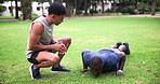 Push ups, exercise or workout with man and personal trainer outdoor in field together for performance. Fitness, sports or clapping for motivation with athlete and coach training at park in summer