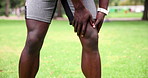 Park, closeup and man with knee pain, injury and legs with inflammation, training and fitness with sports. Person, runner and outdoor with athlete and emergency with accident and muscle tension