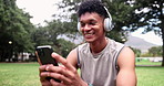 Fitness, phone and happy man with headphones at park on break for streaming music at garden in summer. Sports, smartphone and person listening to radio, typing or laughing at meme on social media