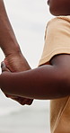 Parent, child and holding hands on beach for support, bonding and holiday with closeup. Back of person or family with kid by the ocean, sea and wind in nature for love, care and safety or security