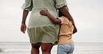 Mother, boy and hug with back at beach with care, love and connection with support on walk by waves. People, mom and child with embrace, together and outdoor on vacation by ocean with adventure