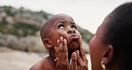 Son, child and mother with affection on beach for bonding, playing and funny face with happiness and talking. Black family, mom and kid by ocean with love, care or conversation on holiday or vacation