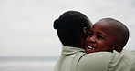 Son, kid and mother with hugging on beach for bonding, playing and affection with happiness or sea waves. Black family, mom and child by ocean with love, care or embrace on holiday, relax or vacation